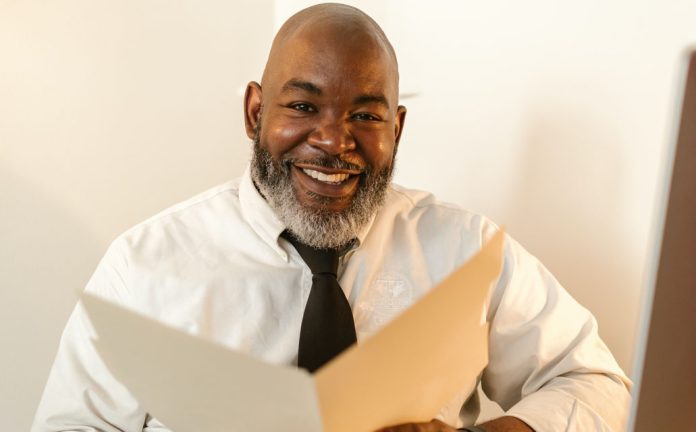 Smiling man holding folder