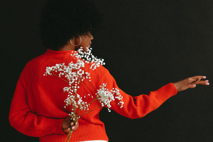 black woman holding flowers